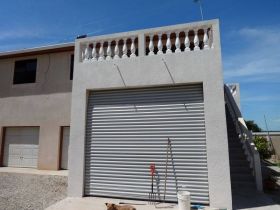 Hurricane shutters on the garage on a home in Corozal, Belize – Best Places In The World To Retire – International Living